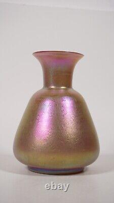 An unmarked art glass pinkish vase iridescent Shimmering bottle glassware