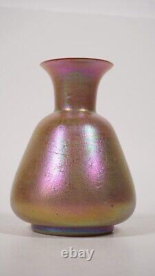 An unmarked art glass pinkish vase iridescent Shimmering bottle glassware