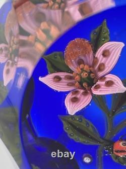 John Deacons Faceted Lampwork Pink Flowers/Ladybug On Blue Base Paperweight