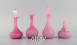 Two vases and two flacons in pink mouth-blown art glass decorated with gold