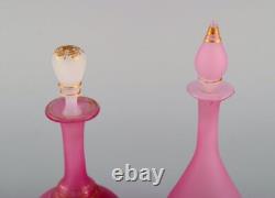 Two vases and two flacons in pink mouth-blown art glass decorated with gold