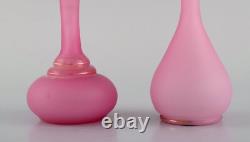 Two vases and two flacons in pink mouth-blown art glass decorated with gold