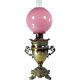 Victorian Banquet Lamp with Lion Heads and Cased Pink Art Glass Globe 1880's